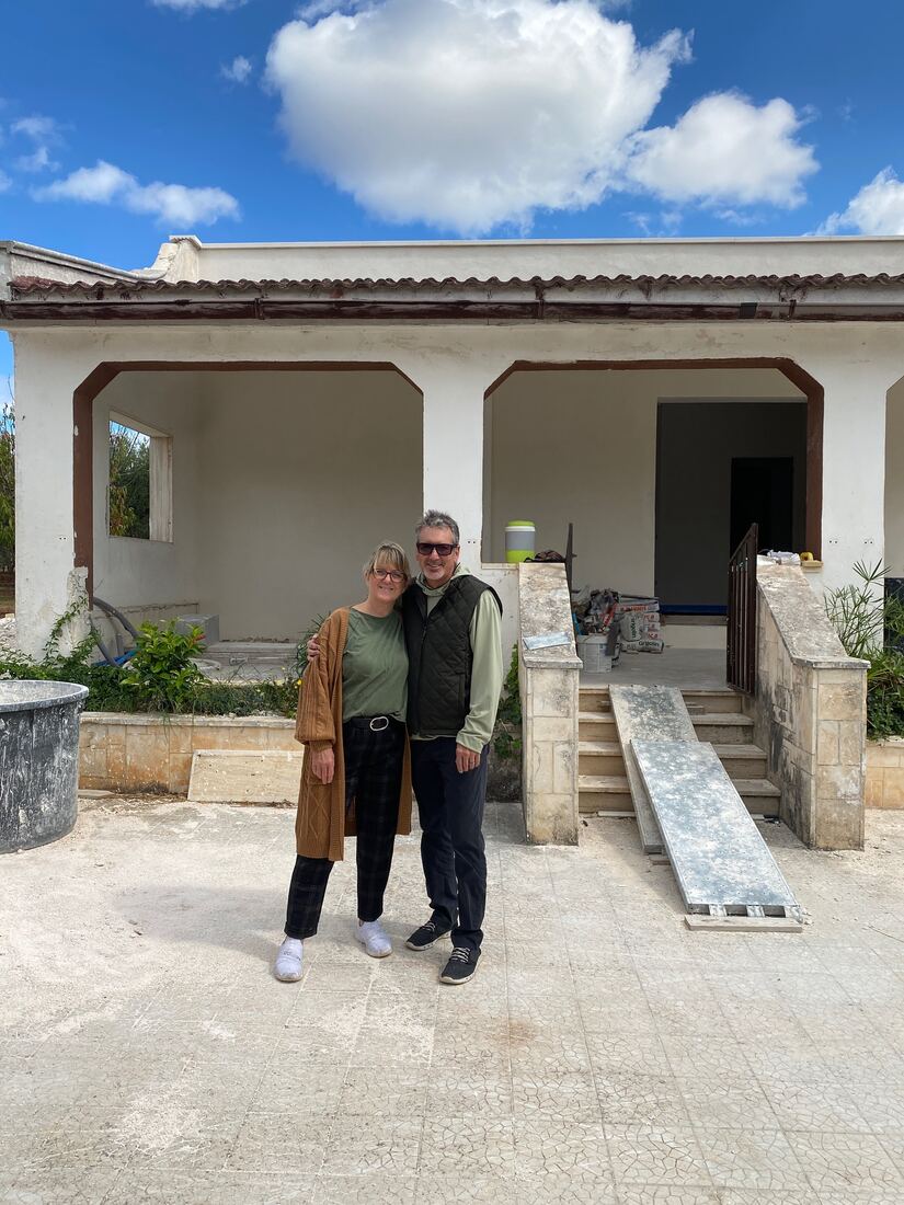 Jan and Chris in front of the farmhouse, mid-renovation